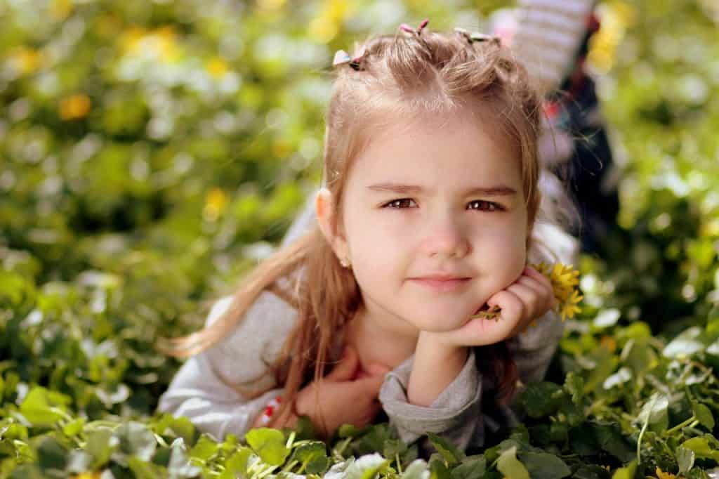 girl laying on the grass