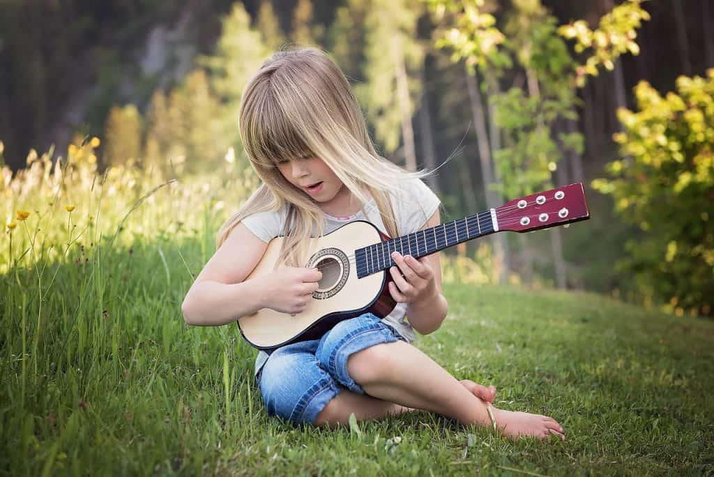 girl playing with ukulele