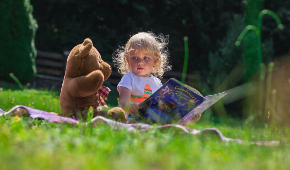 girl sitting with teddy bear