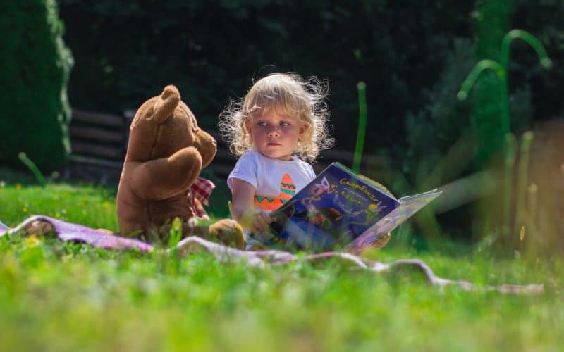 girl sitting with teddy bear