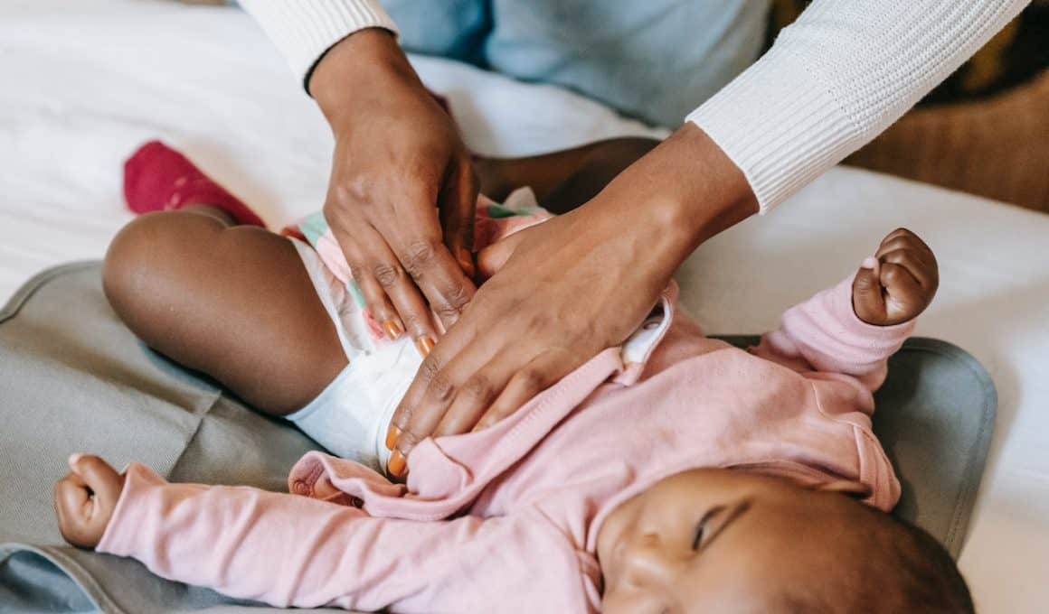 lady putting diaper on baby