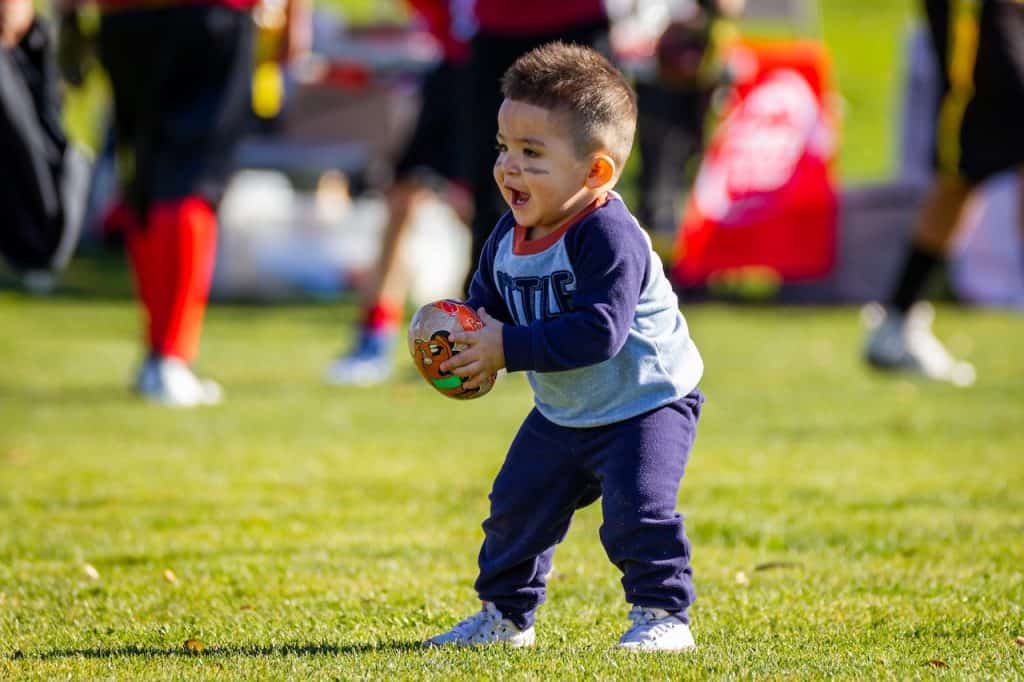 little boy holding football