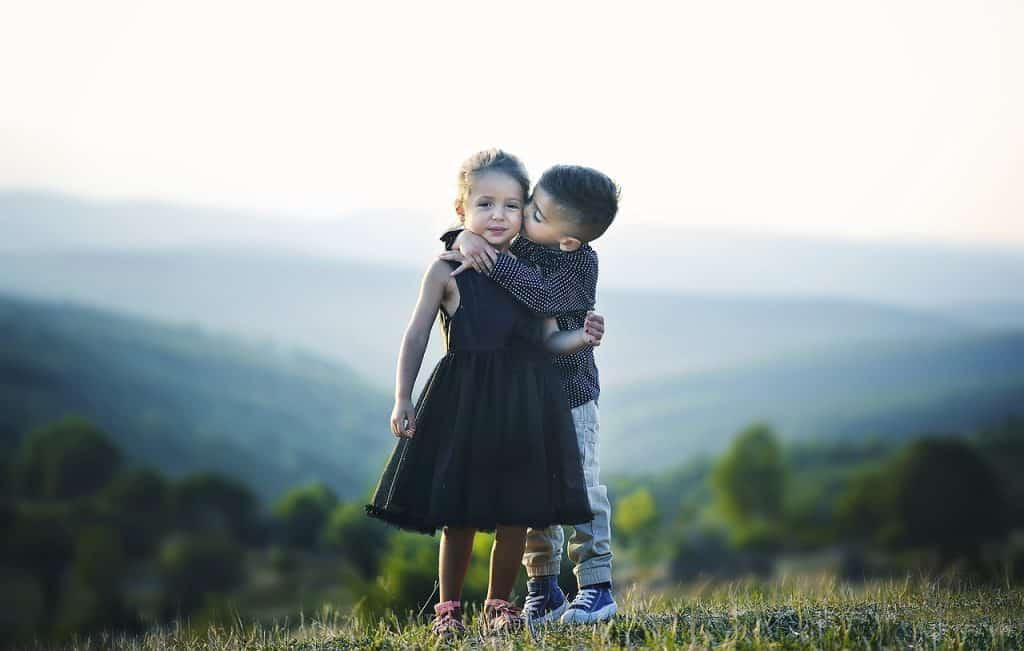 little boy kissing a girl