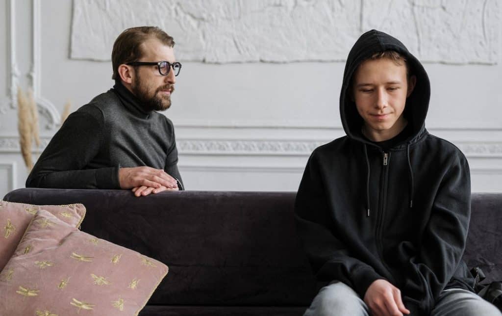 man talking to a teenage boy