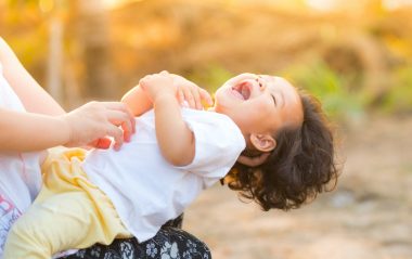 mom tickling baby