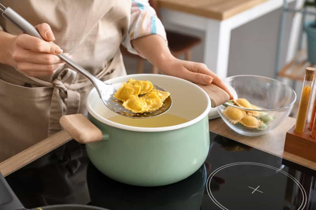 person cooking ravioli