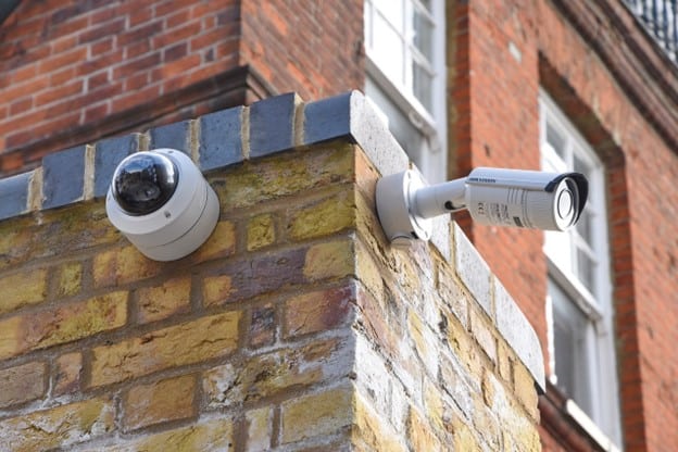 surveillance cameras on a brick wall