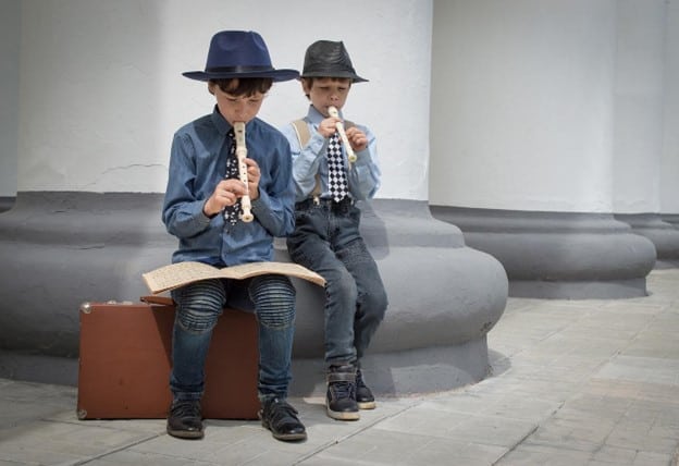 two boys playing flute