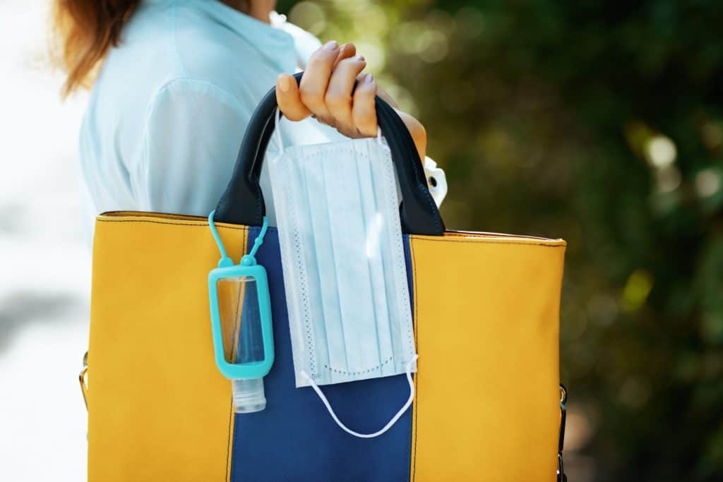 woman holding a bag and mask