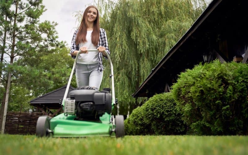 woman mowing the lawn