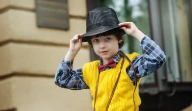 boy wearing hat and checkered shirt