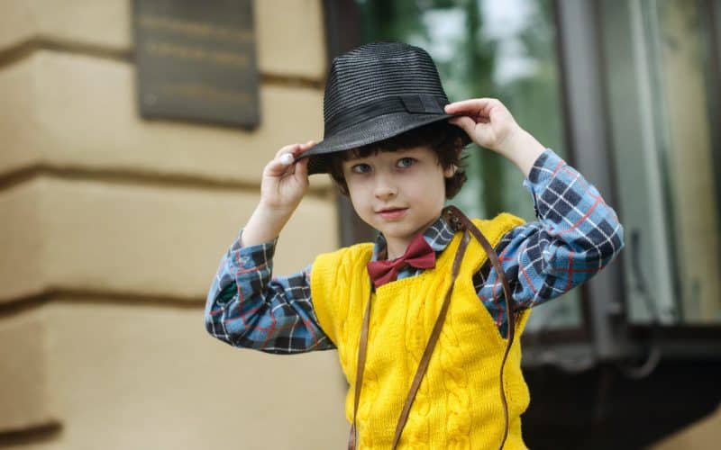 boy wearing hat and checkered shirt