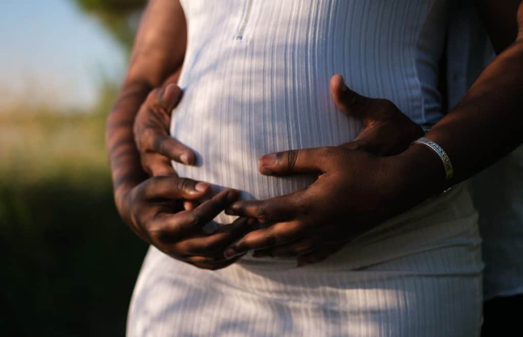 couple holding pregnant belly