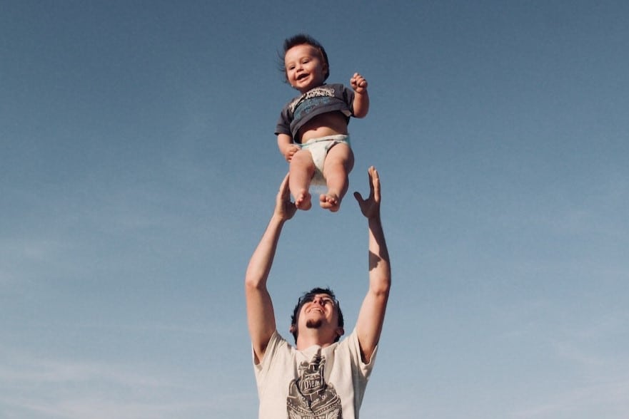 dad throwing baby up in the air