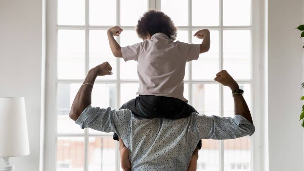 father and son flexing their muscles