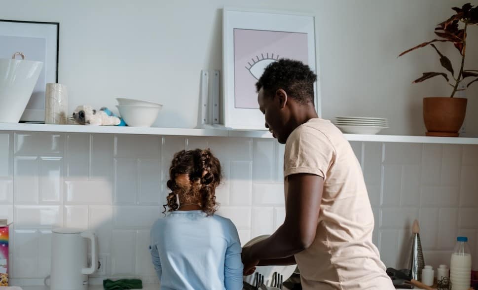 girl and man washing dishes