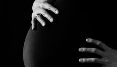 greyscale photo of a pregnant woman