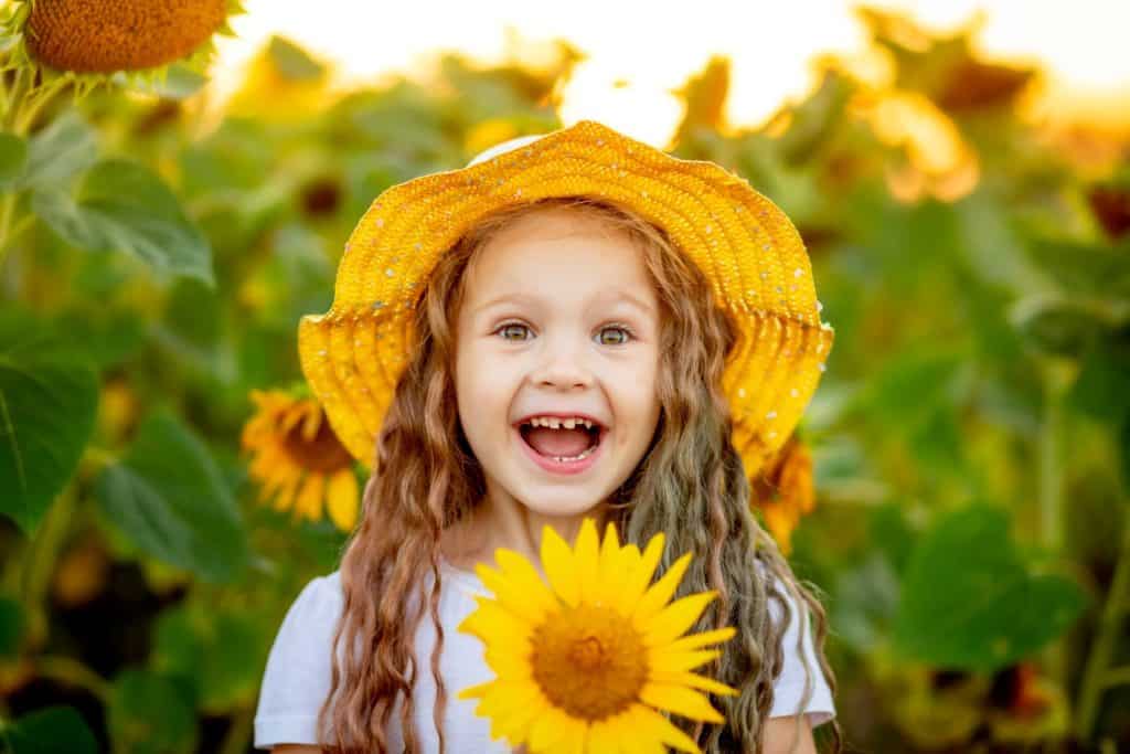 happy girl holding sunflower