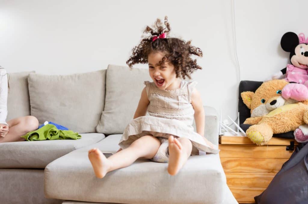 little girl sitting on a sofa