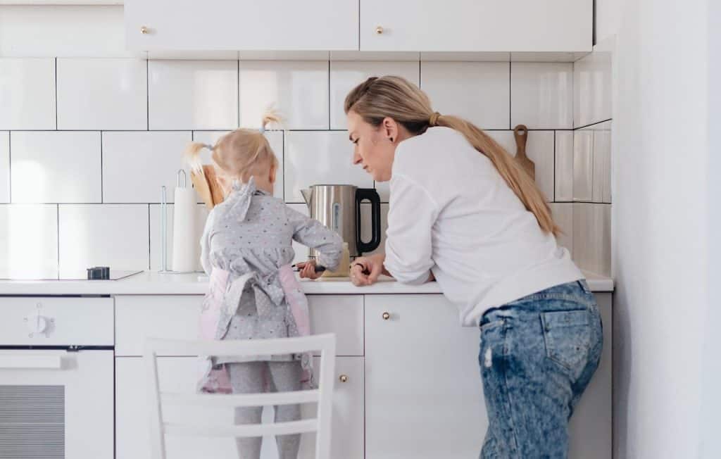 mom and toddler preparing food in the kitchen