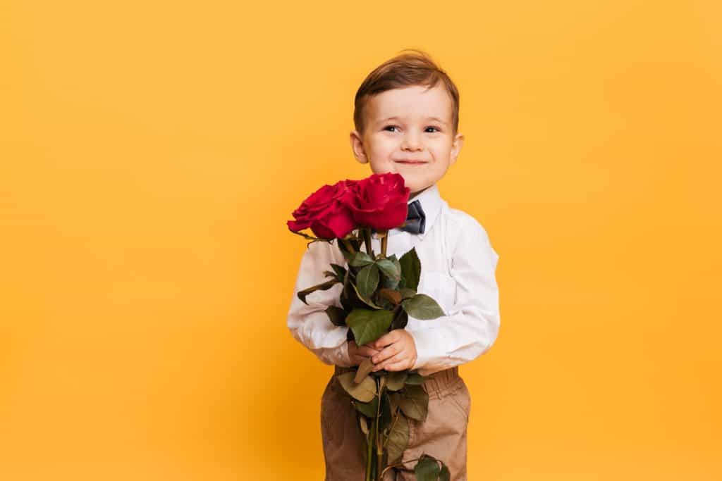 toddler holding rose