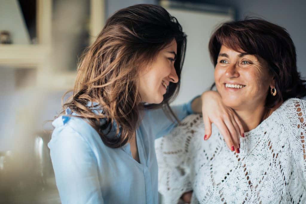 two woman smiling at each other