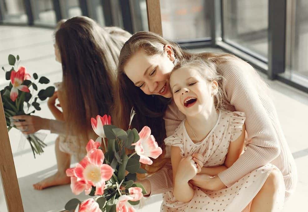 woman and girl sitting on the floor