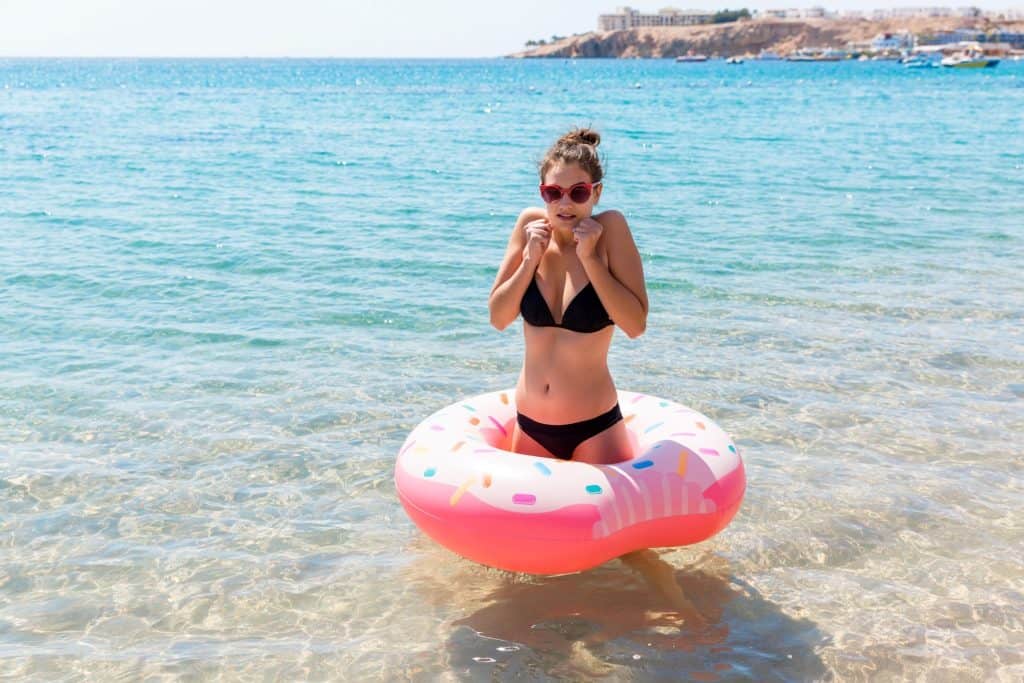 woman in bikini with donut bouy