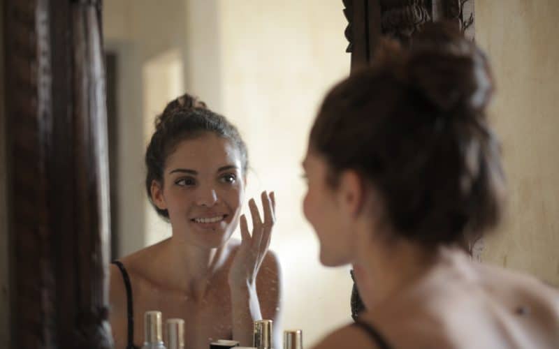 woman smiling in front of the mirror