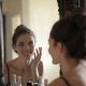 woman smiling in front of the mirror