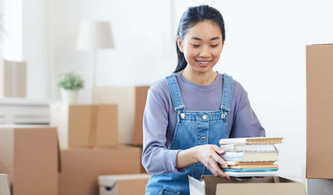 young woman packing books