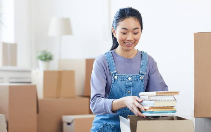 young woman packing books