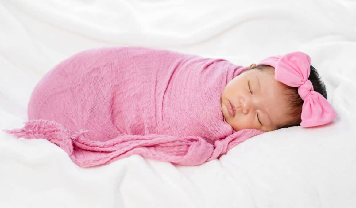 baby on a pink swaddle