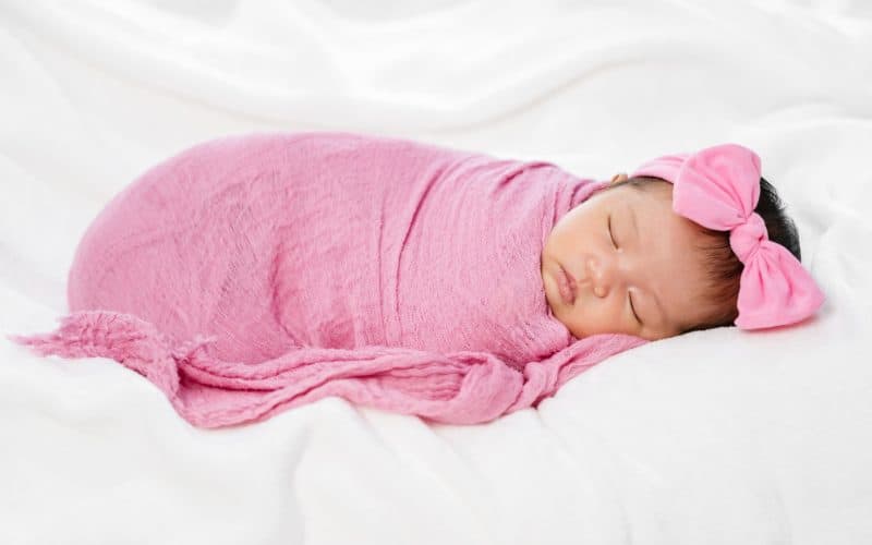 baby on a pink swaddle