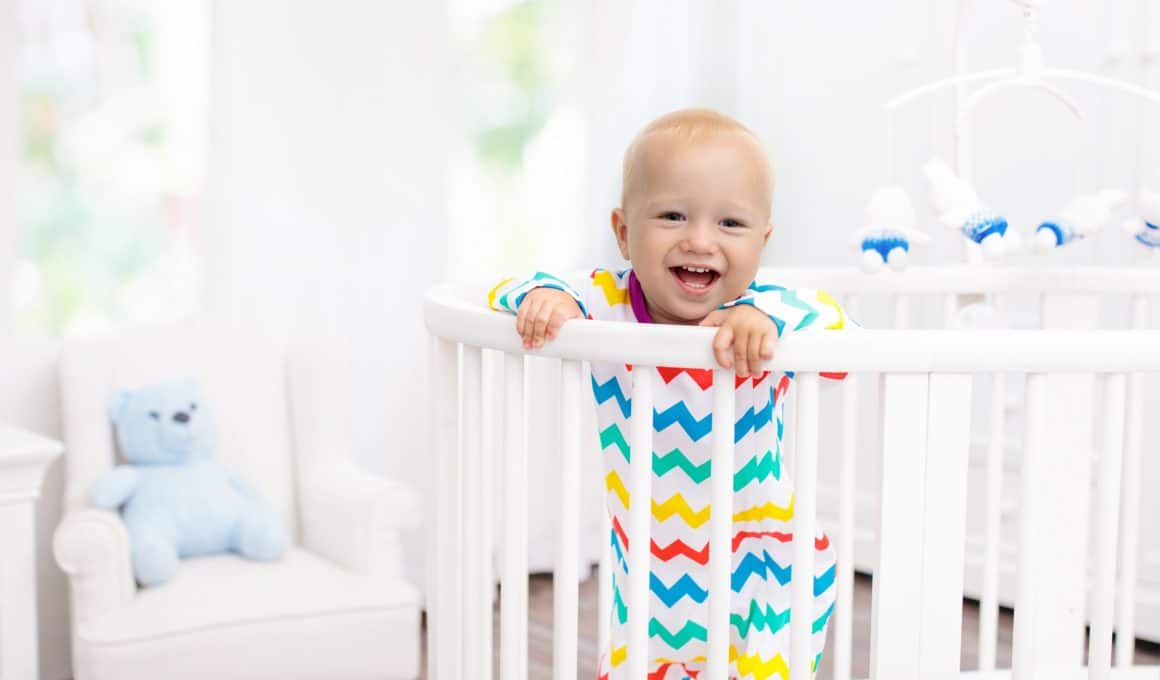 baby smiling on a crib