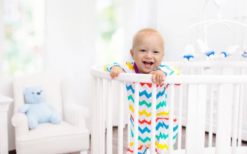 baby smiling on a crib