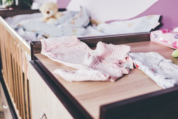baby's crib with clothes
