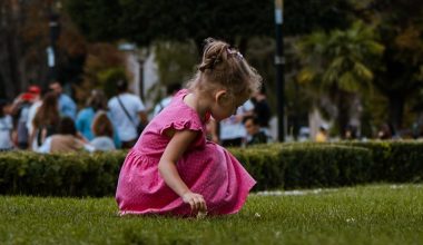 girl in pink dress playing outdoor