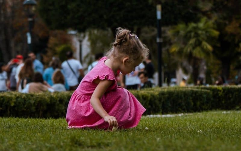 girl in pink dress playing outdoor