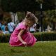 girl in pink dress playing outdoor