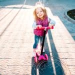little girl riding on a scooter