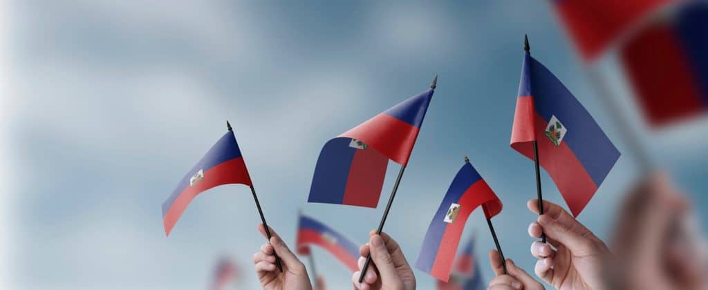 people holding Haitian flag