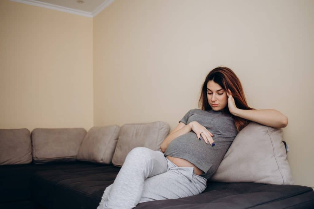 pregnant woman sitting on a sofa