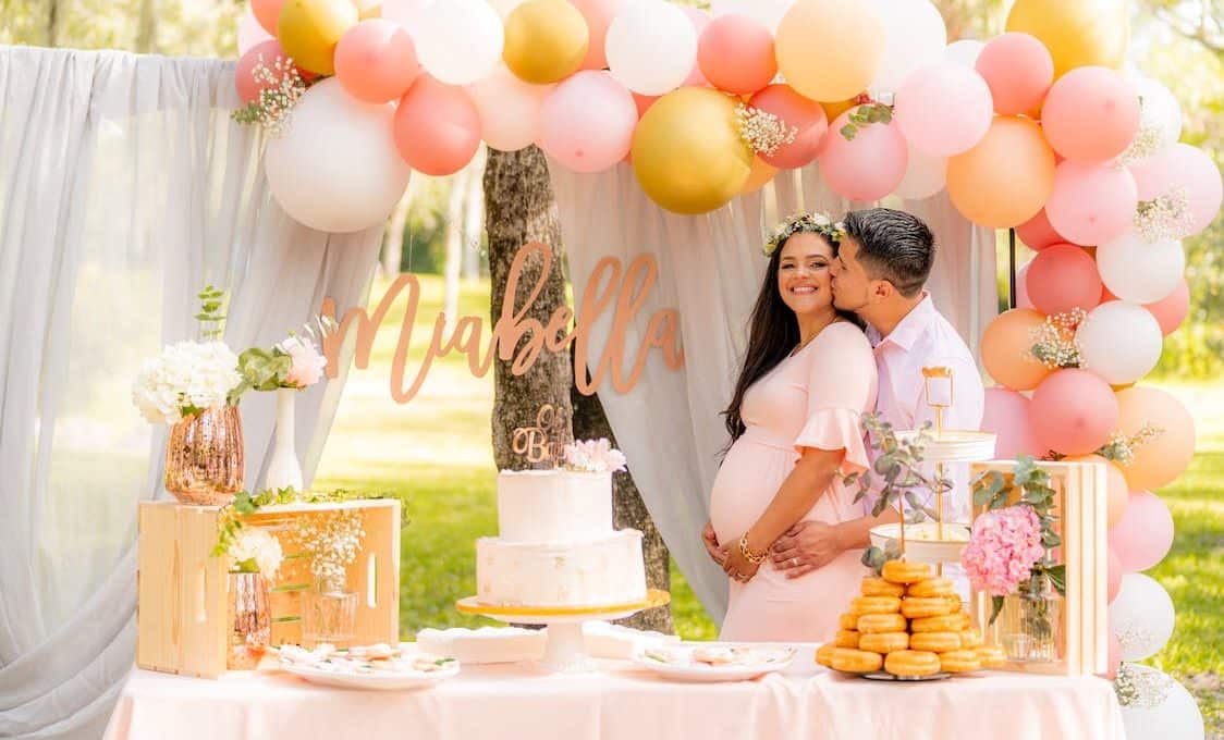 man kissing a woman during a baby shower