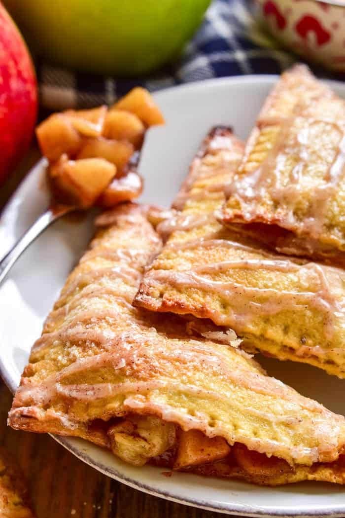 Apple brie turnovers served with drizzle of cinnamon glaze on top.