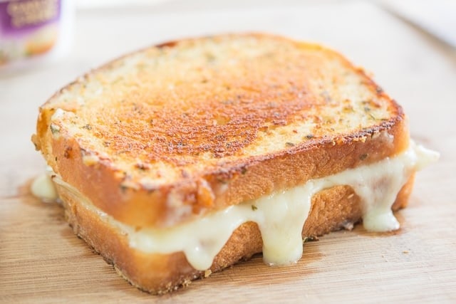 Grilled sandwich with melted cheese filling.