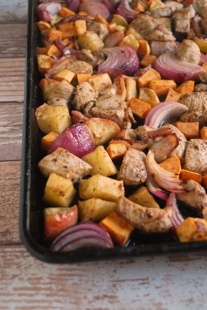 Jamaican jerk chicken cooked in a sheet pan with potato, apple, and bacon. 