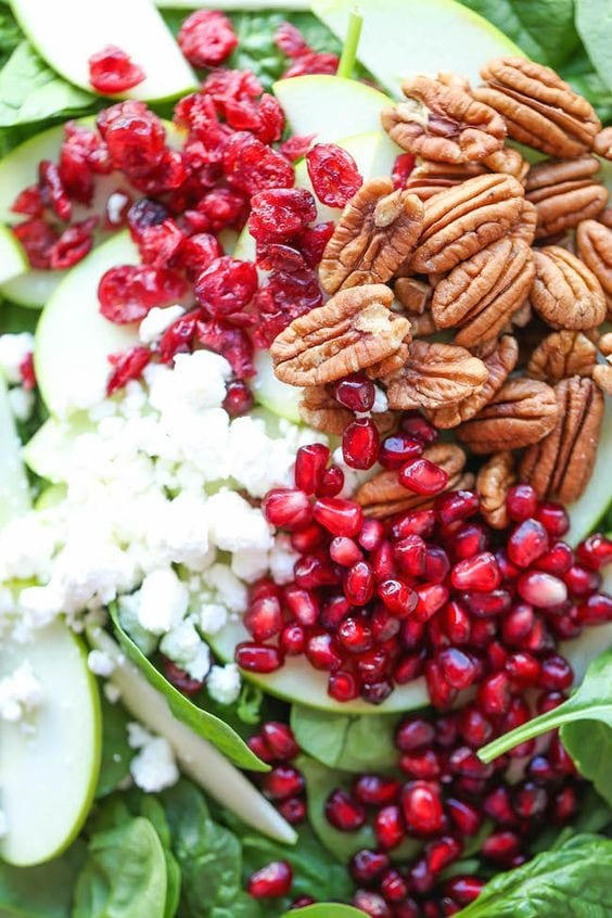 apple-cranberry-pecan-salad Apple cranberry pecan salad with chunks of crisp apple, nutty pecans, and bright pomegranate seeds.