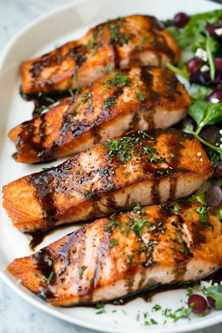 balsamic-salmon Slices of salmon with balsamic glaze served on a white plate.