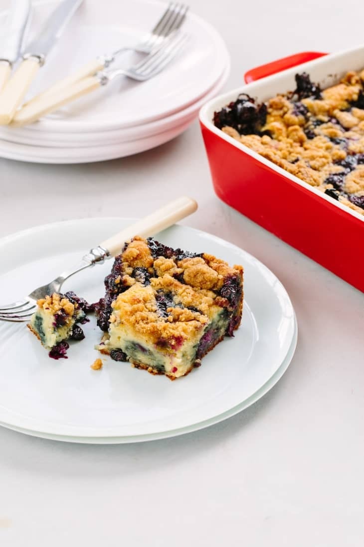 bluberry-pancake-caserrole Blueberry pancake casserole slice on a white plate with fork.